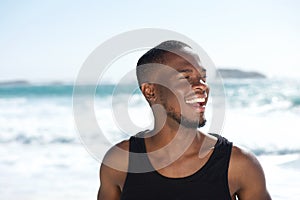 Handsome young african american man laughing at the beach