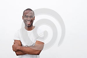 Handsome young african american man smiling with arms crossed against isolated white background