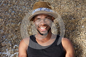 Handsome young african american man smiling with hat