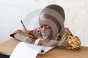 Handsome Young African Boy Writing and Learning in School Building
