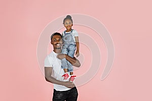 Handsome young african man have fun with cute child baby girl 3-4 years old.