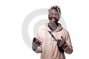 Handsome young african man pointing with finger at phone isolated on white background