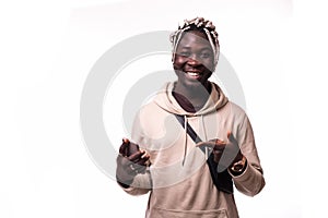 Handsome young african man pointing with finger at phone isolated on white background