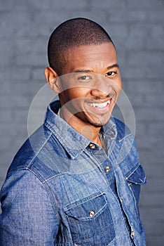 Handsome young african man smiling with blue shirt