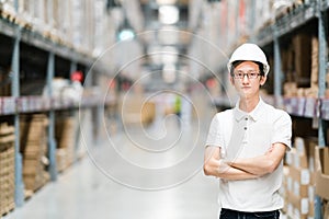 Handsome young Asian engineer or technician or worker, warehouse or factory blur background, industry or logistic concept