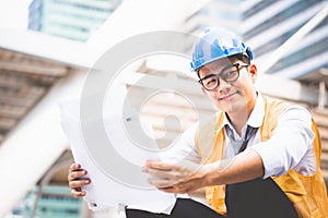 Handsome young asian man engineer or architect in a building construction site