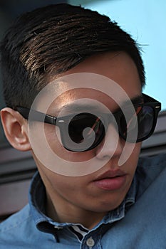 Handsome young Asian man in sunglasses