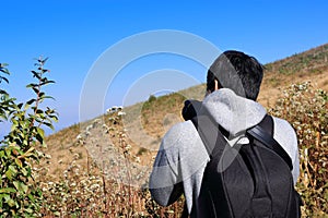 Handsome young Asian tourist man taking picture with dslr camera at Kew Mae Pan nature trail at Doi Inthanon , Chaingmai , Thailan photo