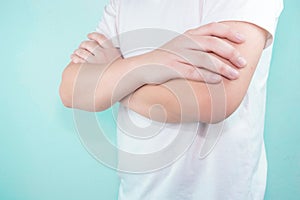 Handsome young Asian wearing a white T-shirt standing with arms folded isolate on white background