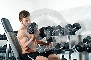 Handsome young athlete working out at the gym