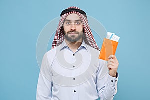 Handsome young bearded arabian muslim man in keffiyeh kafiya ring igal agal casual clothes isolated on pastel blue