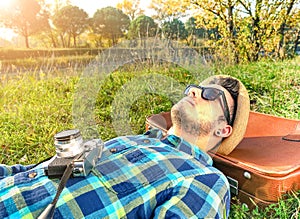Handsome young bearded hipster relaxing with old camera