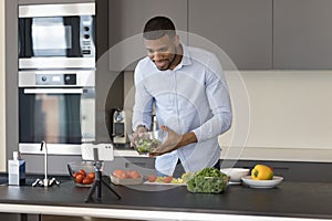 Handsome young Black cock blogger man recording healthy eating masterclass