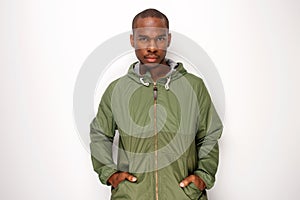 Handsome young black man with jacket against isolated white background