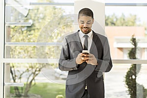 Handsome young black man with mobile phone