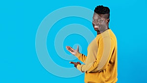 Handsome Young Black Man Pointing At Copy Space With Two Hands