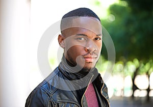 Handsome young black man posing outside