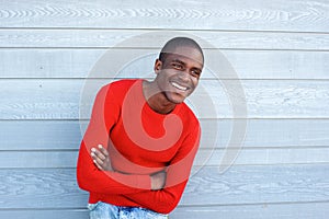 Handsome young black man smiling with arms crossed