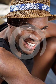 Handsome young black man smiling with hat