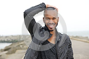 Handsome young black man smiling outdoors