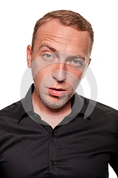 Handsome young blond man in a black shirt, isolated on a white background