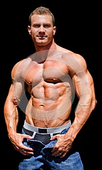 Handsome young bodybuilder shirless, isolated on black