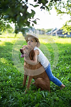 Handsome Young Boy Playing with His Dog at the park