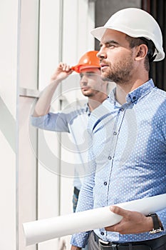 Handsome young builders are working on project