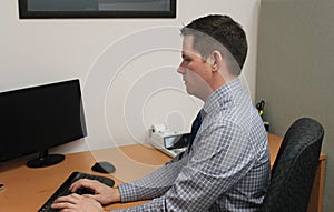 Handsome Young Business Man at Desk in Accounting Office