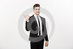 Handsome young business man happy smile point finger to empty copy space, businessman showing pointing side, concept of
