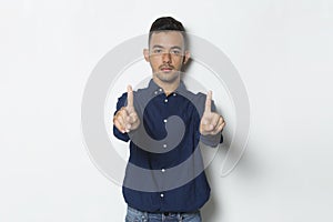 Handsome young business man with open hand doing stop sign with serious expression defense gesture isolated on white background