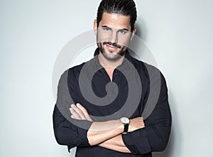 Handsome young business man in suit on grey background