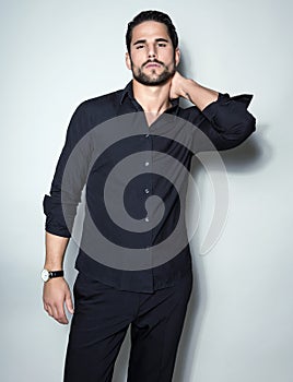 Handsome young business man in suit on grey background