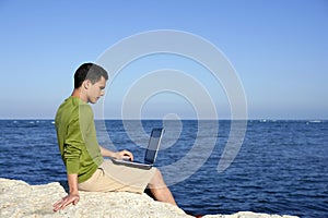 Handsome young businessman computer beach