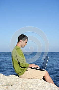 Handsome young businessman computer beach