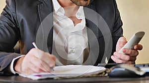 Handsome young businessman at desk on phone