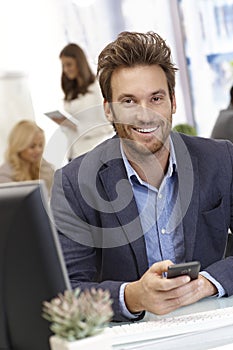 Handsome young businessman with mobilephone