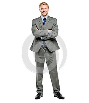 Handsome young businessman posing with his arms folded in studio. Fullbody confident friendly caucasian businessperson