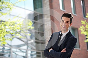 Handsome young businessman smiling outdoors