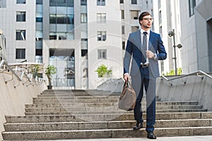 handsome young businessman in stylish suit with briefcase