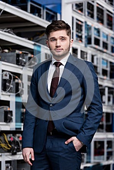 handsome young businessman in stylish suit at cryptocurrency