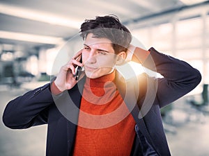 Handsome young businessman talking on cell phone