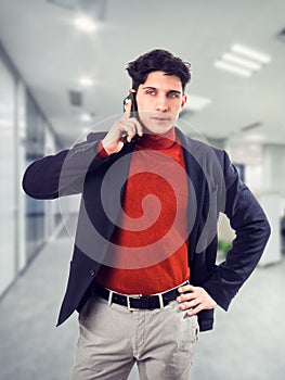 Handsome young businessman talking on cell phone