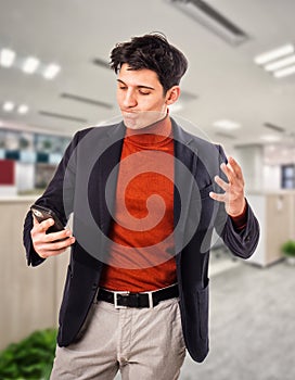 Handsome young businessman talking on cell phone