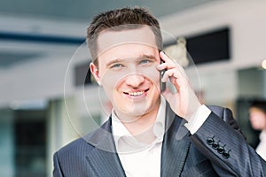 Handsome young businessman talking on his mobile