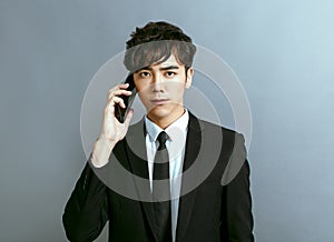 Handsome young businessman talking on mobile phone