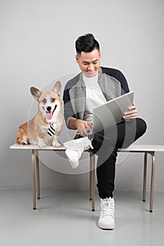 Handsome young businessman is using laptop while sitting with hi