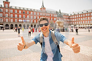 Handsome young caucasian tourist man happy and excited taking a selfie in Plaza Mayor, Madrid Spain