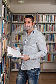 Handsome Young College Student In A Library