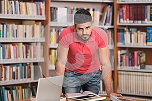 Handsome Young College Student In A Library